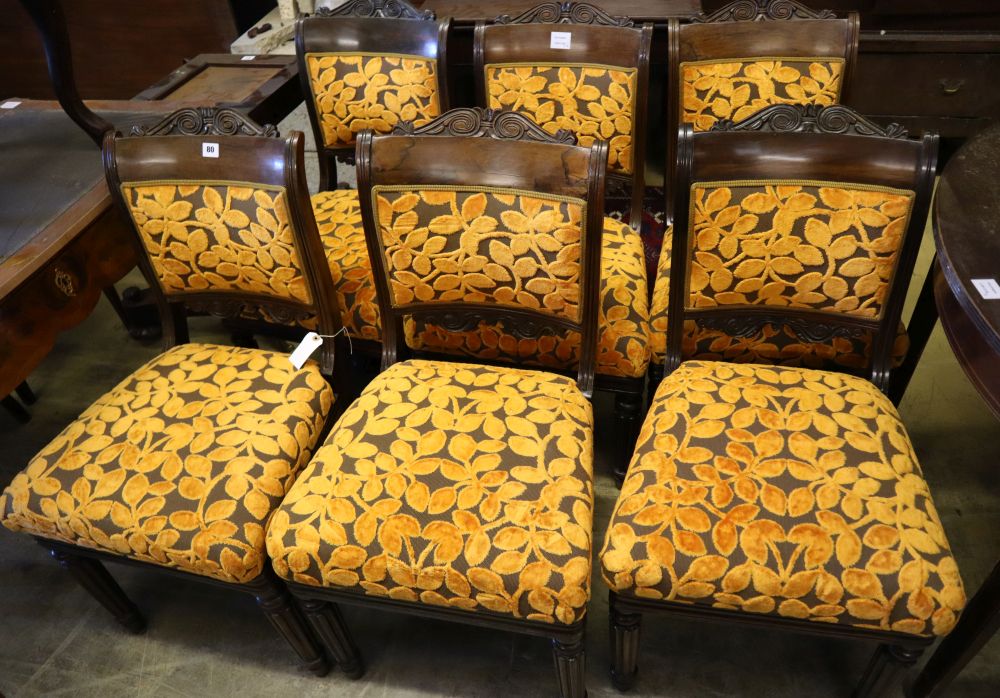 A set of six early 19th century Anglo-Indian rosewood dining chairs, with carved frames and padded seats on fluted legs